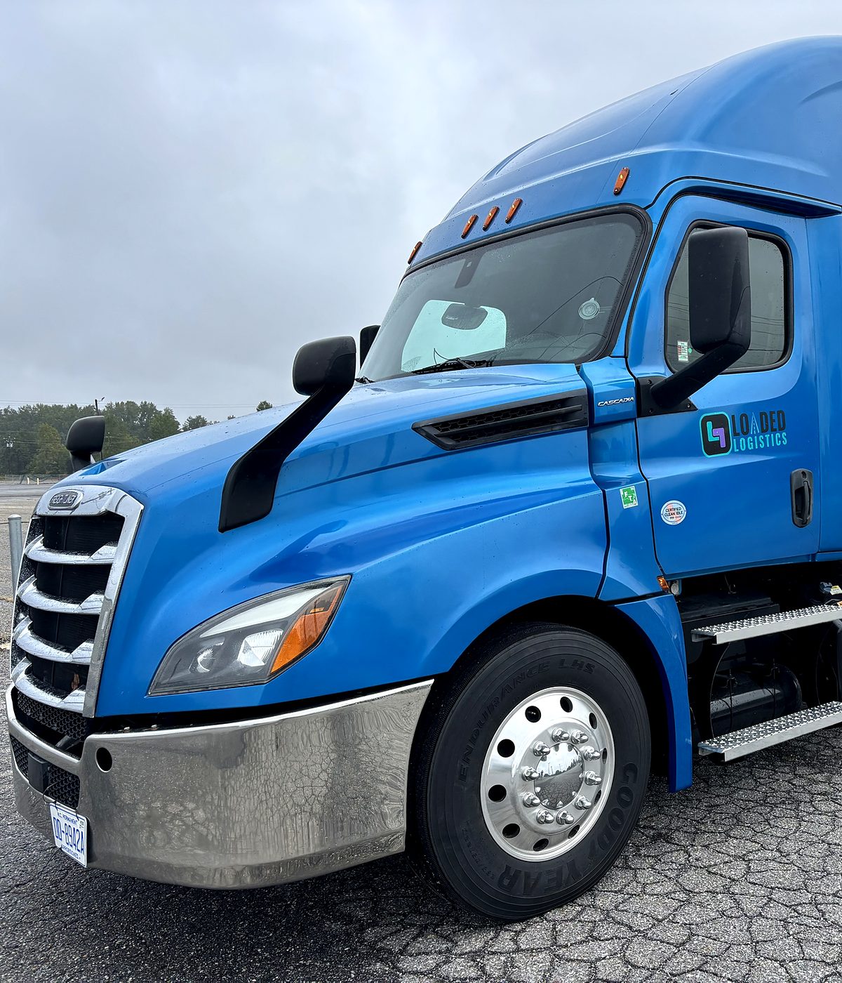 Front three-quarter view of the Loaded Logistics Freightliner Cascadia, the truck you would be driving.